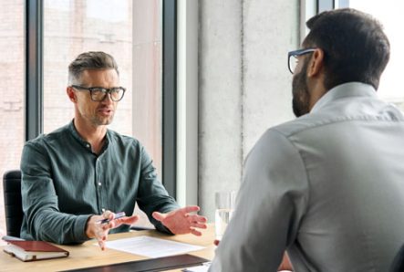 Two Businessmen Reviewing Executive Employment Agreement